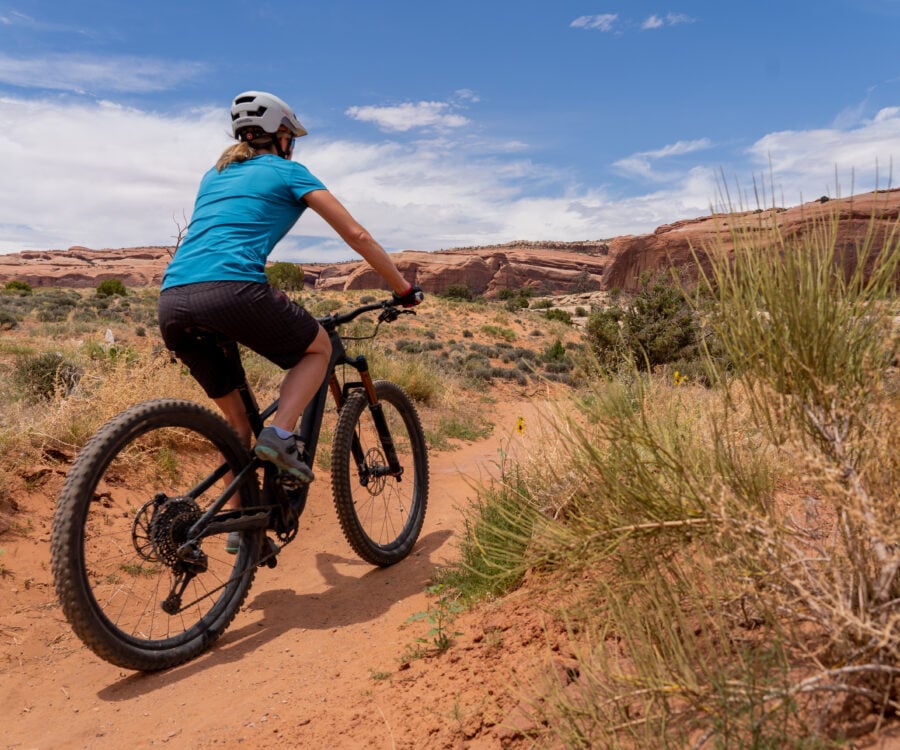 Woman mountain biking in Moab, UT