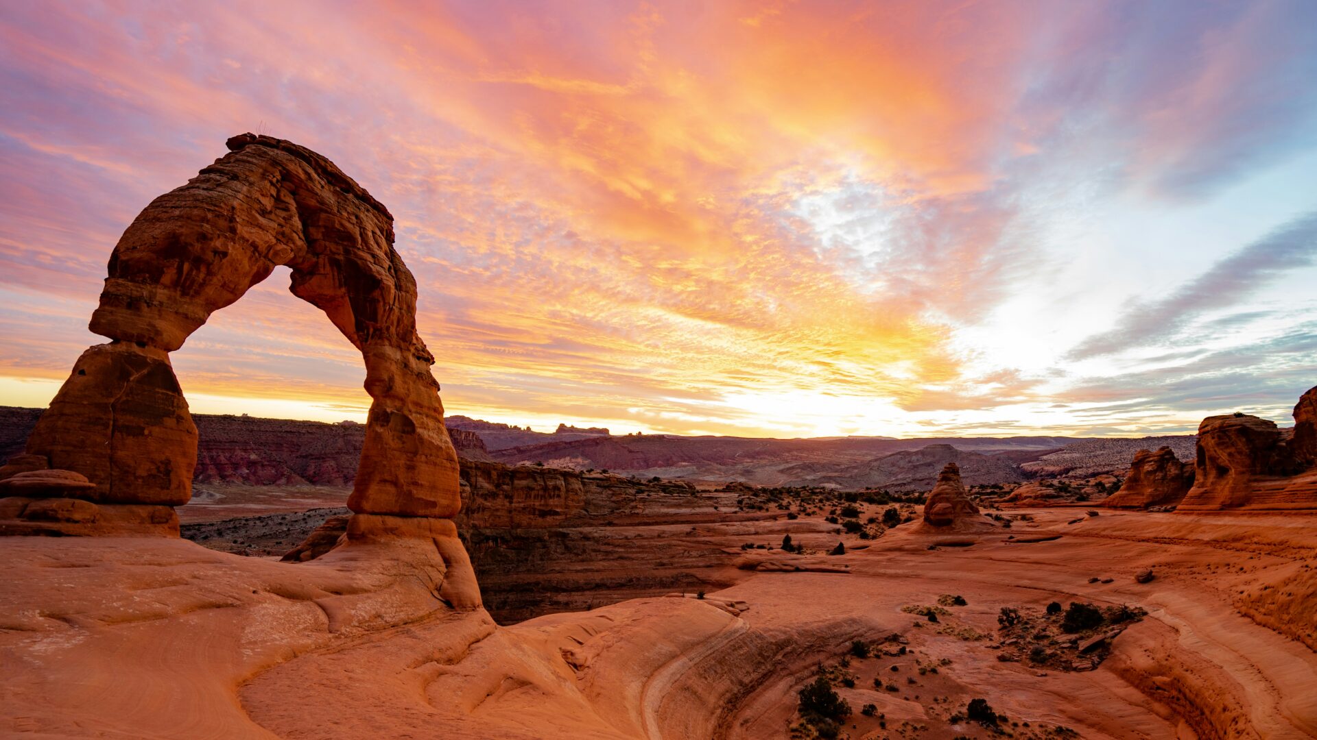 A sunset behind Delicate Arch in Arches National Park, Utah.