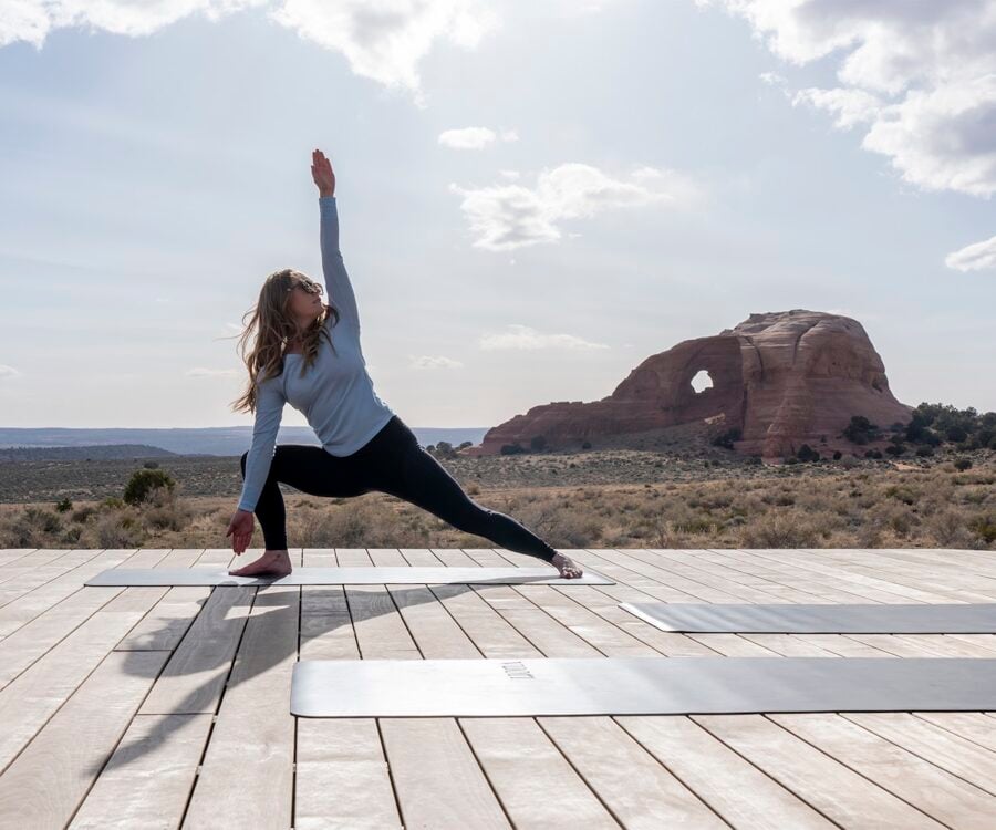 Woman doing yoga in front of Looking Glass Arch.