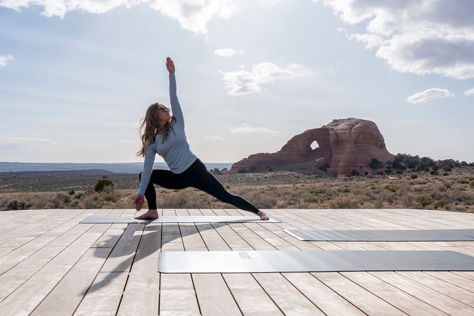 Woman doing yoga in front of Looking Glass Arch.