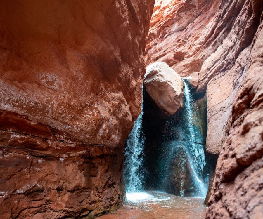 Waterfall at the end of a slot canyon hike in Moab, Utah