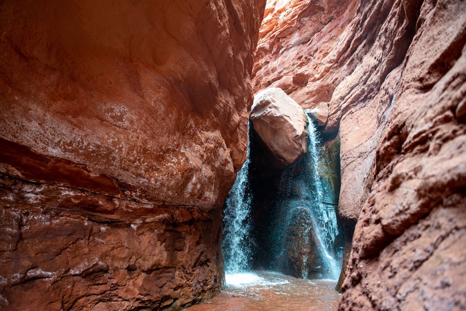 Waterfall at the end of a slot canyon hike in Moab, Utah