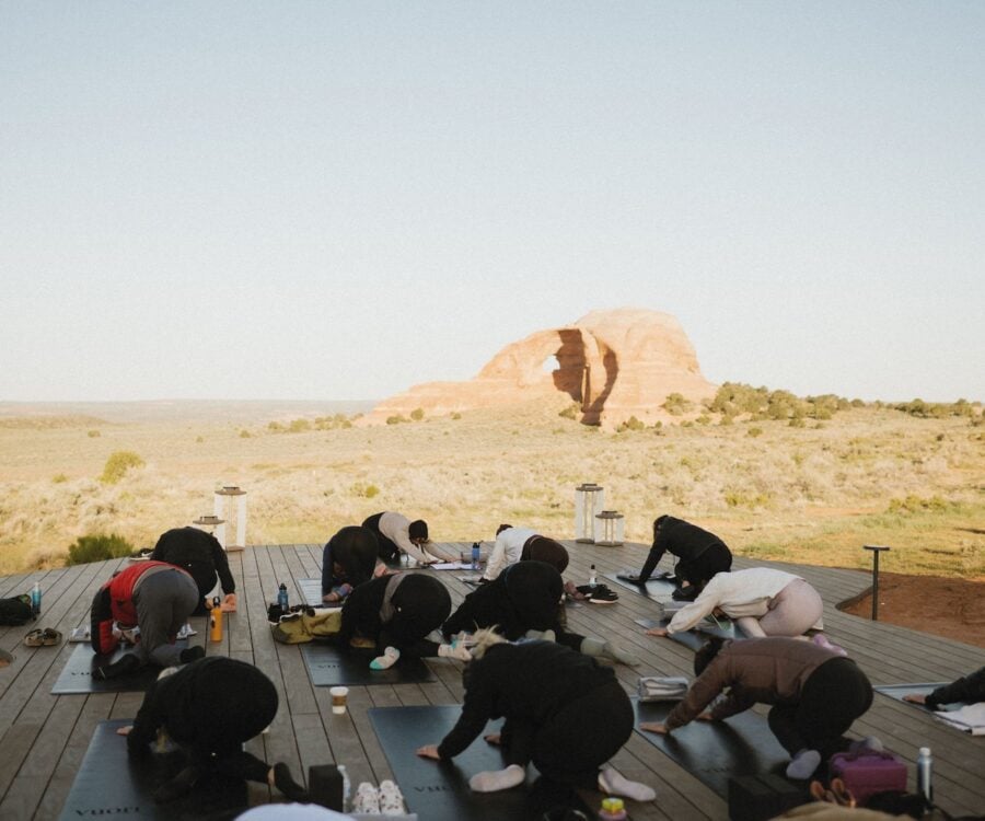 Yoga in front of Looking Glass Arch at ULUM resorts.