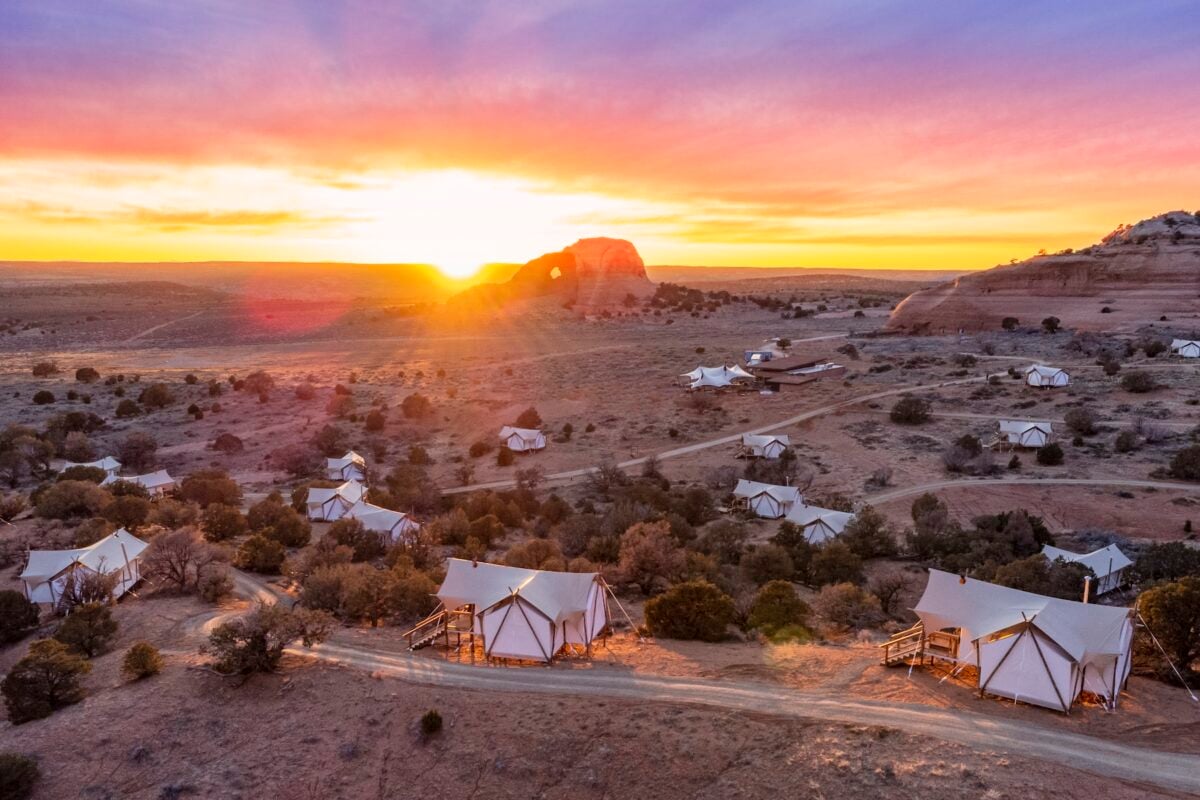 Aerial view of ULUM Moab during sunset with Looking Glass Arch in the background.