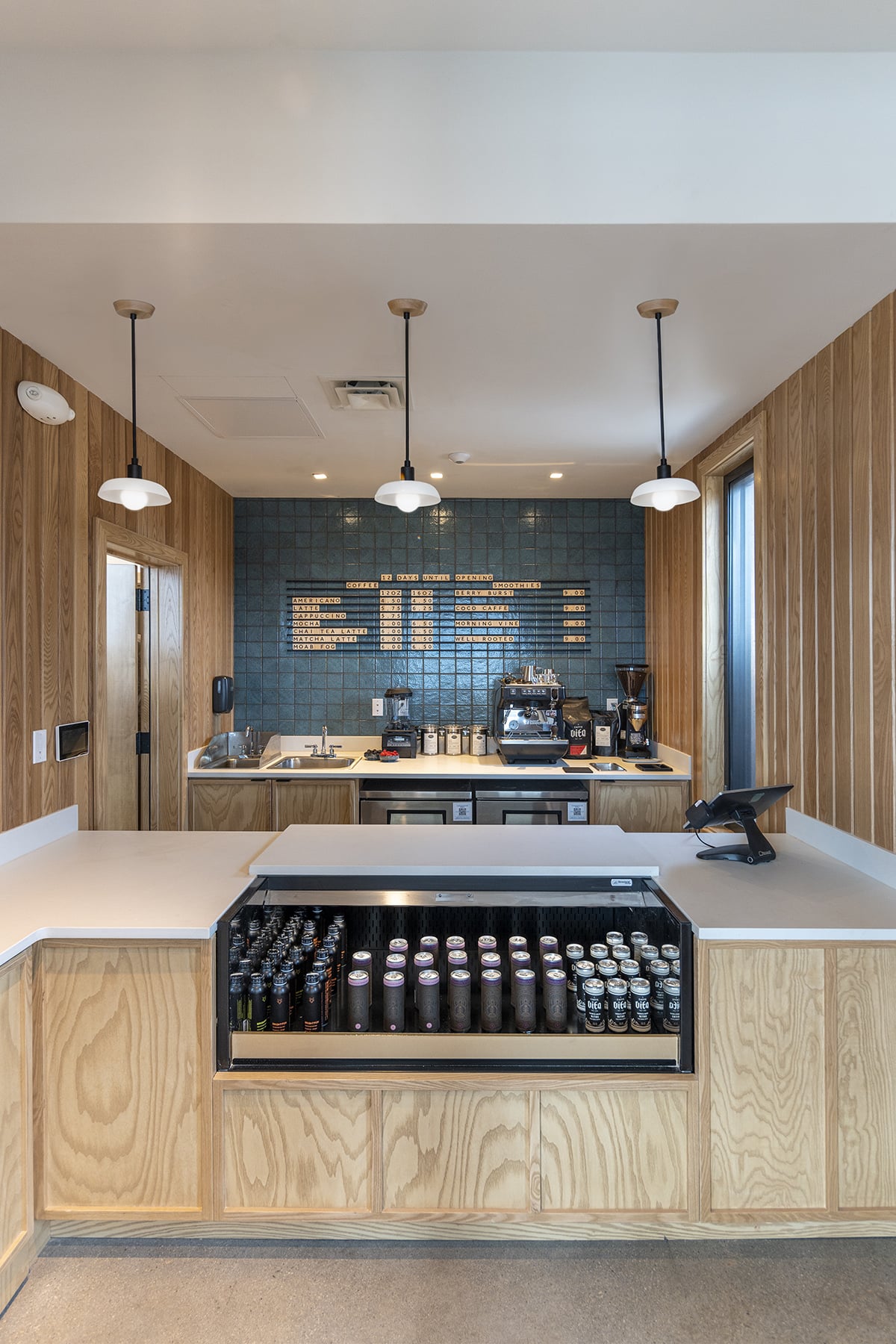 a modern lobby coffee bar with a beer fridge