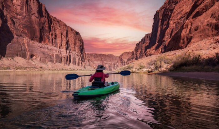 View of woman Kayaking on the Colorado River at Sunset