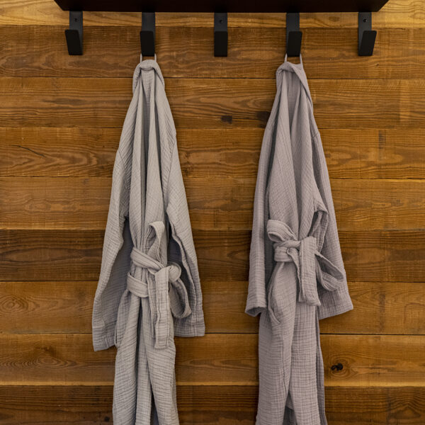 Parachute by ULUM bath robes hanging outside of the en-suite bathroom at ULUM Moab
