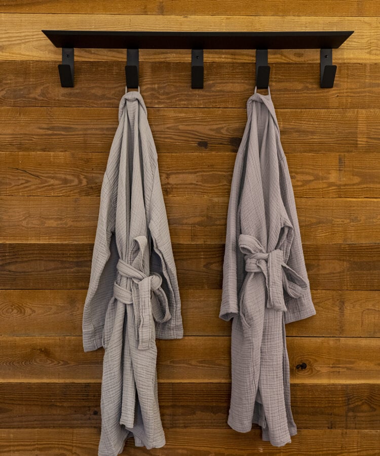 Parachute by ULUM bath robes hanging outside of the en-suite bathroom at ULUM Moab