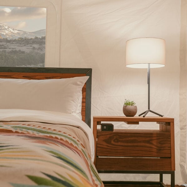 Shot of bed in Suite Tent at ULUM Moab featuring Pendleton wool blankets and Parachute linens