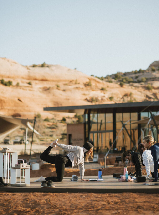 Woman doing yoga on the deck at ULUM Moab